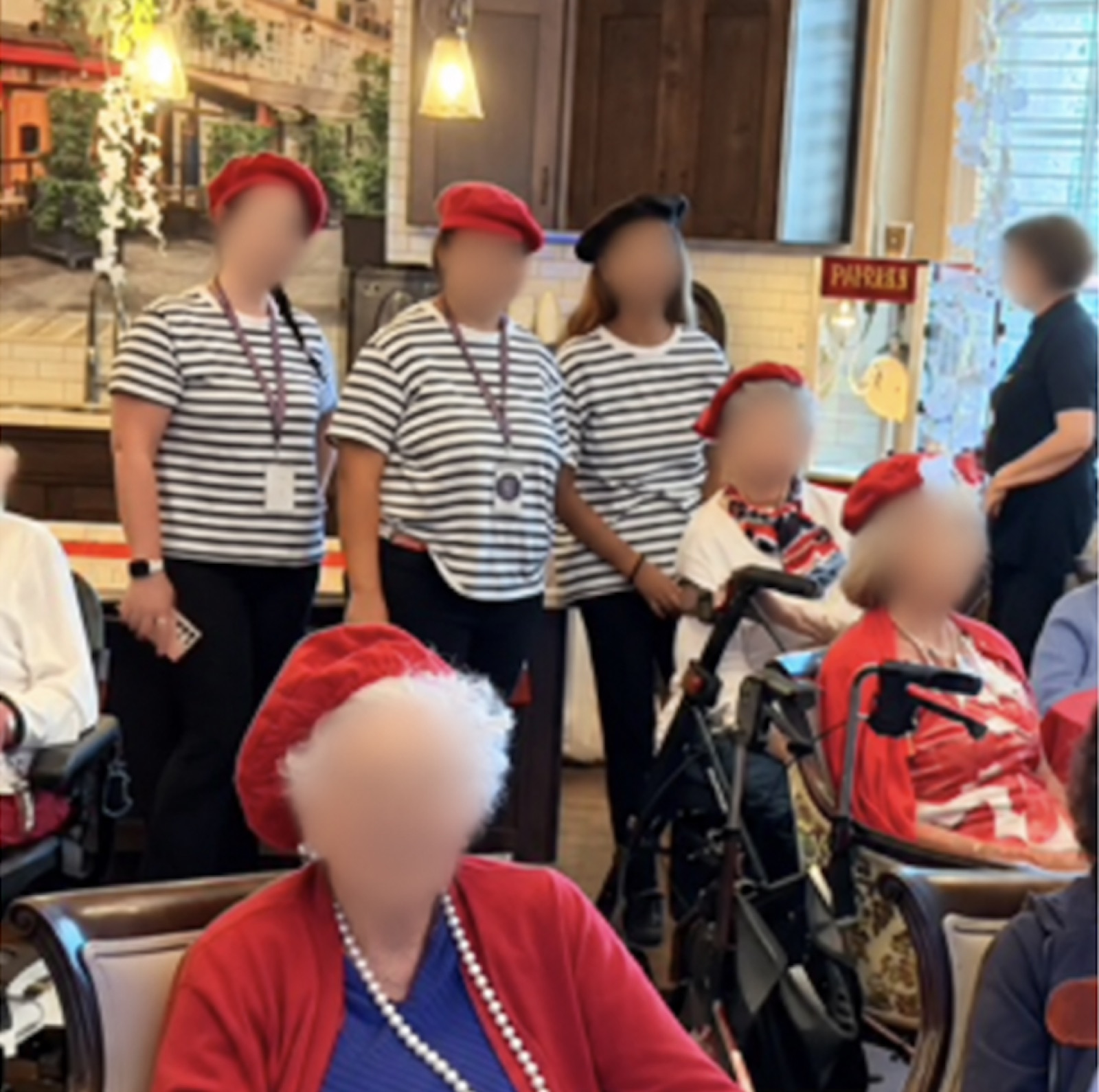 Residents and hosts in berets and striped shirts gathered for a French Salon session.