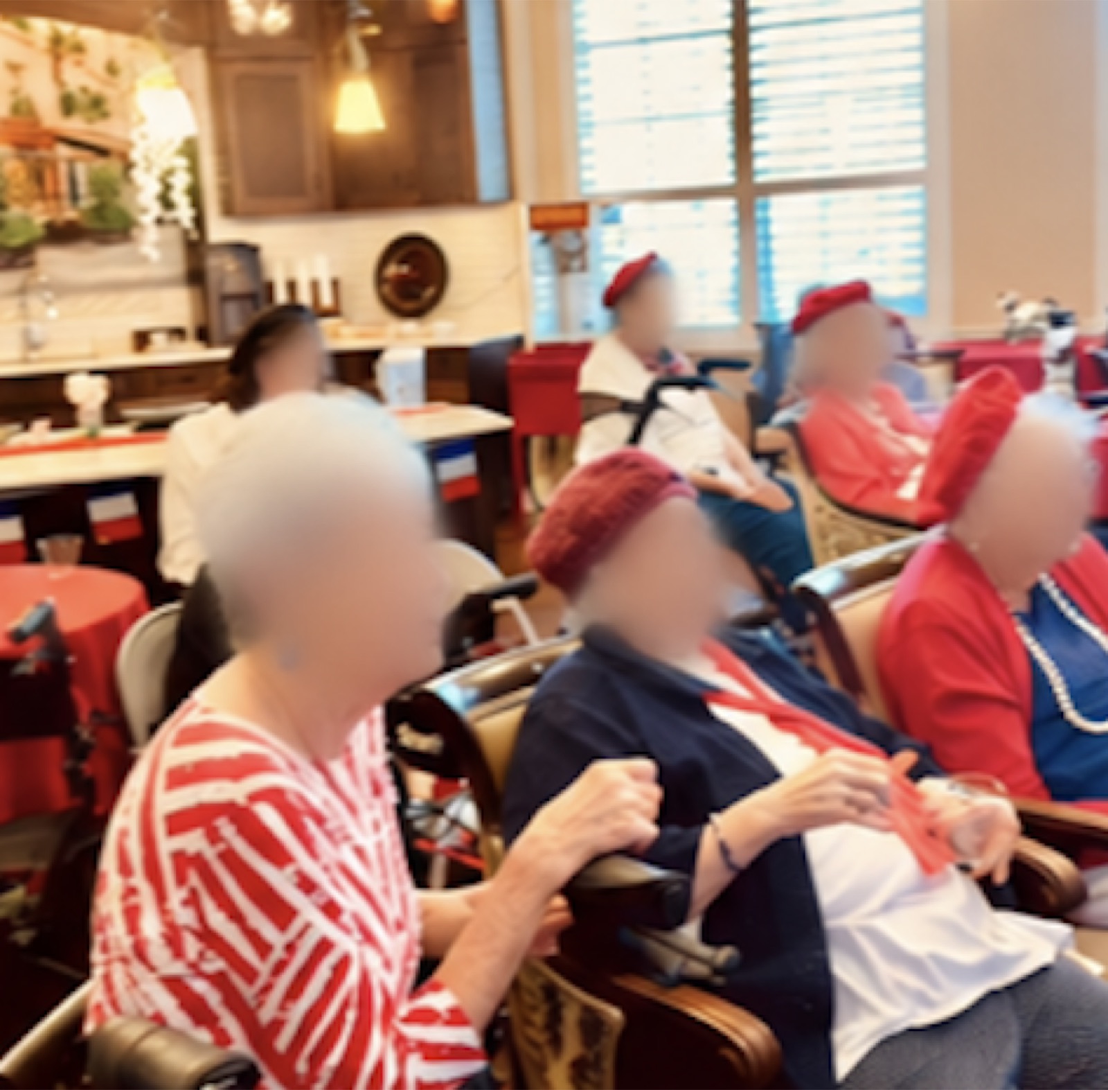 Residents in red berets seated together during a French Salon session.